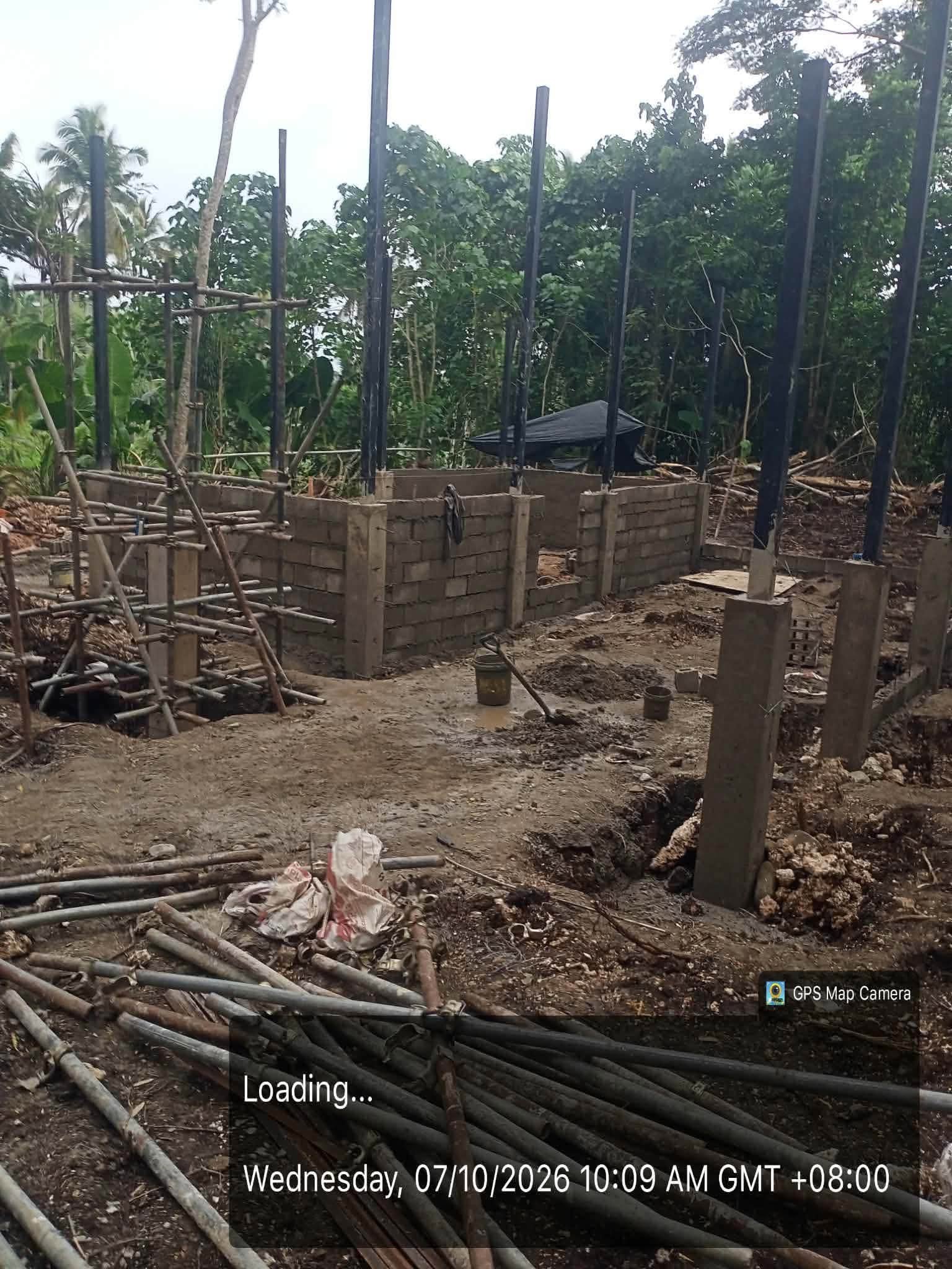 Masonry walls and structural columns under construction at the sanitary offices project in Barangay Buburay.