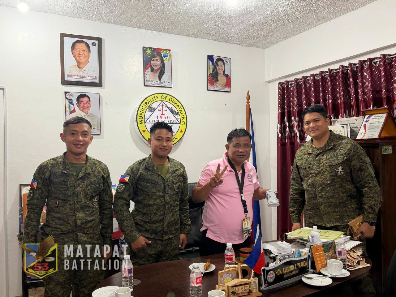 Army personnel and municipal representatives pose inside the Dimataling mayor’s office.
