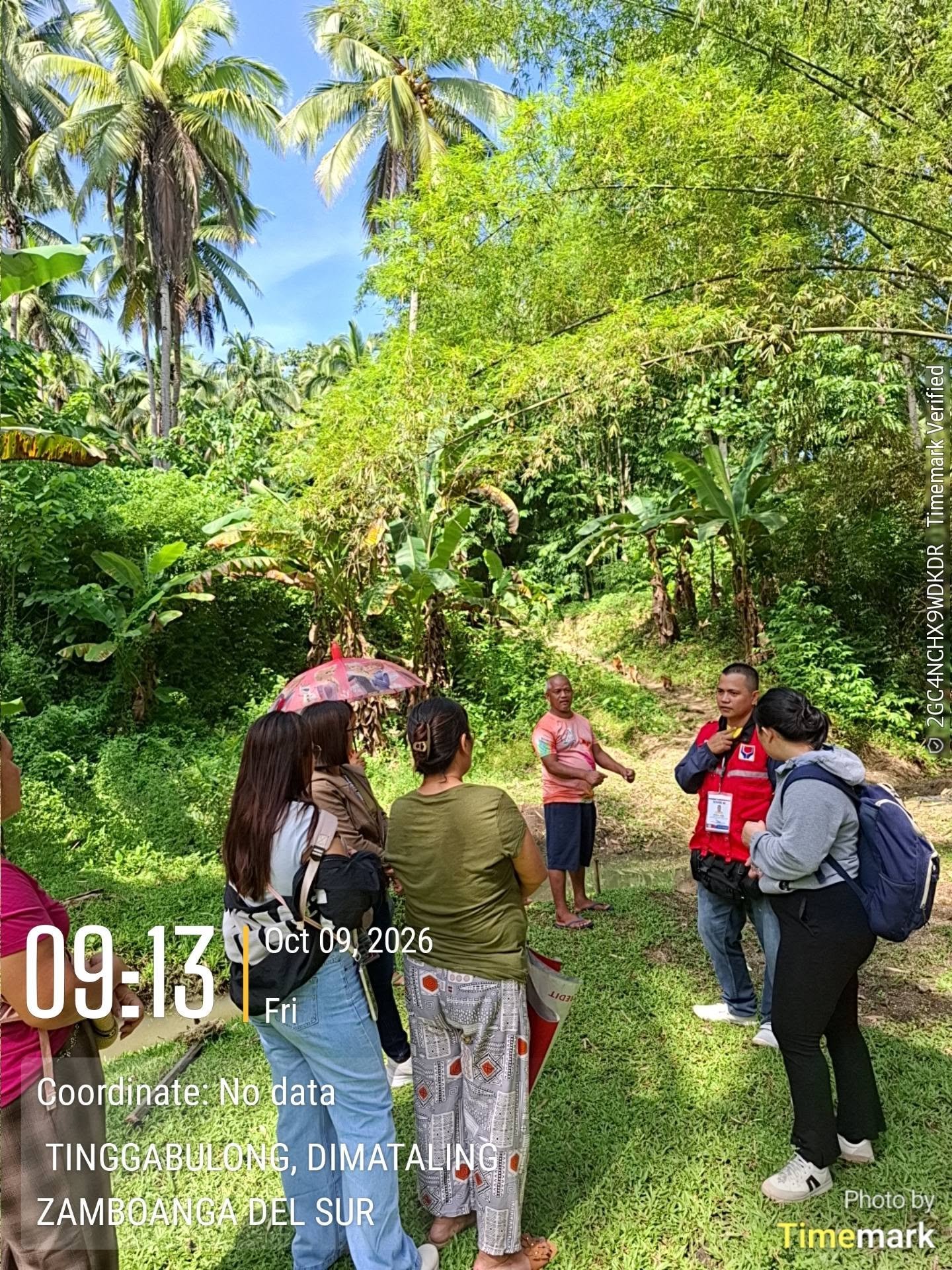 Validation-team members discuss a site during the October 9 field visit.