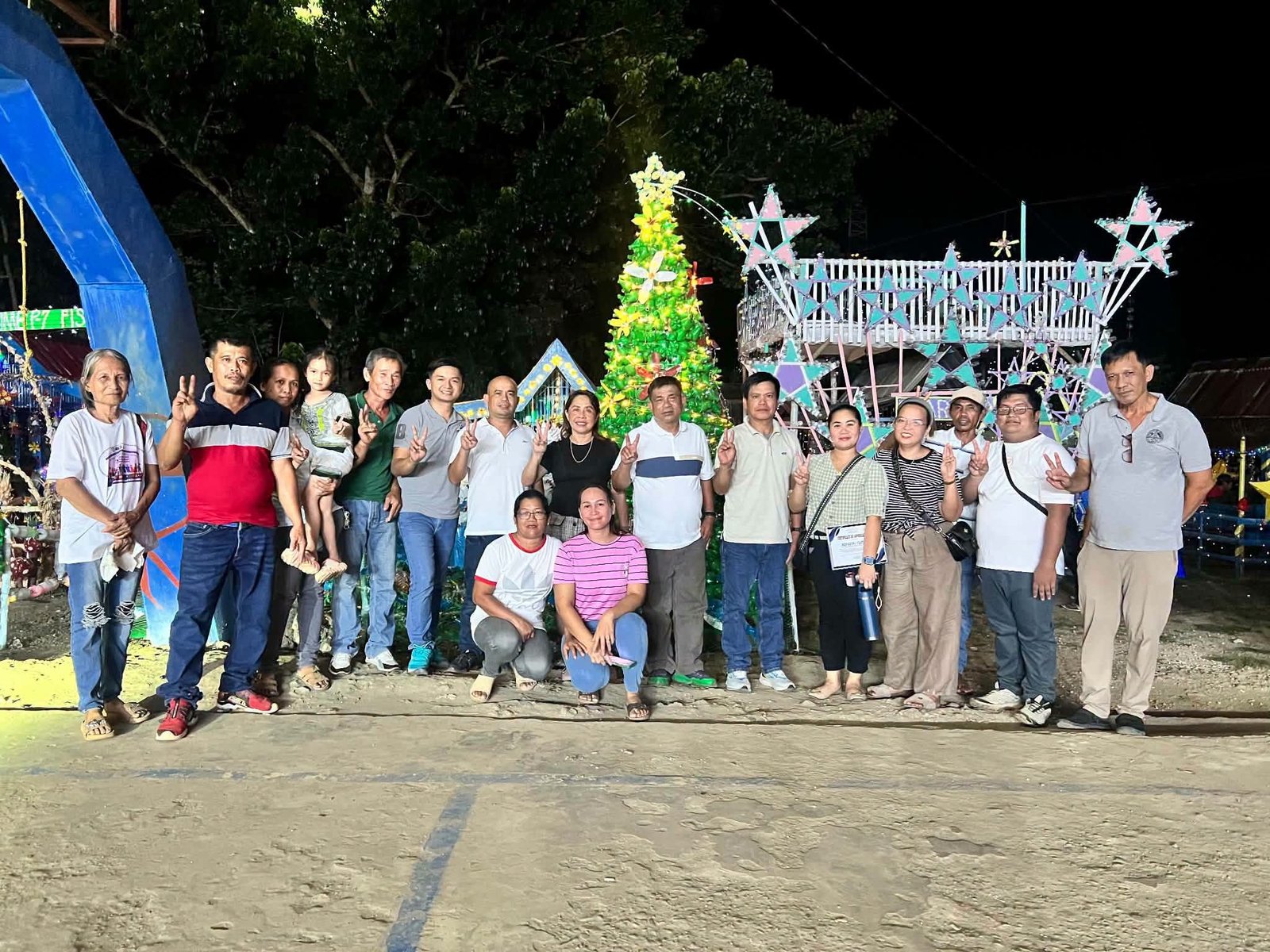 Residents gather beside an illuminated recycled-material Christmas display in Libertad.