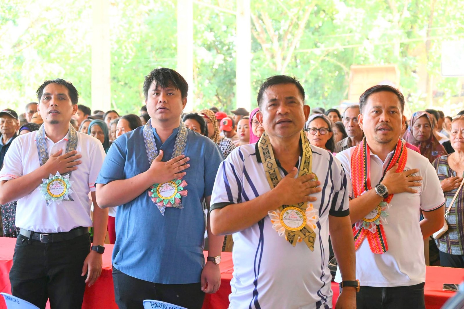 Residents and municipal personnel gather at the rice distribution in the Municipal Gymnasium.