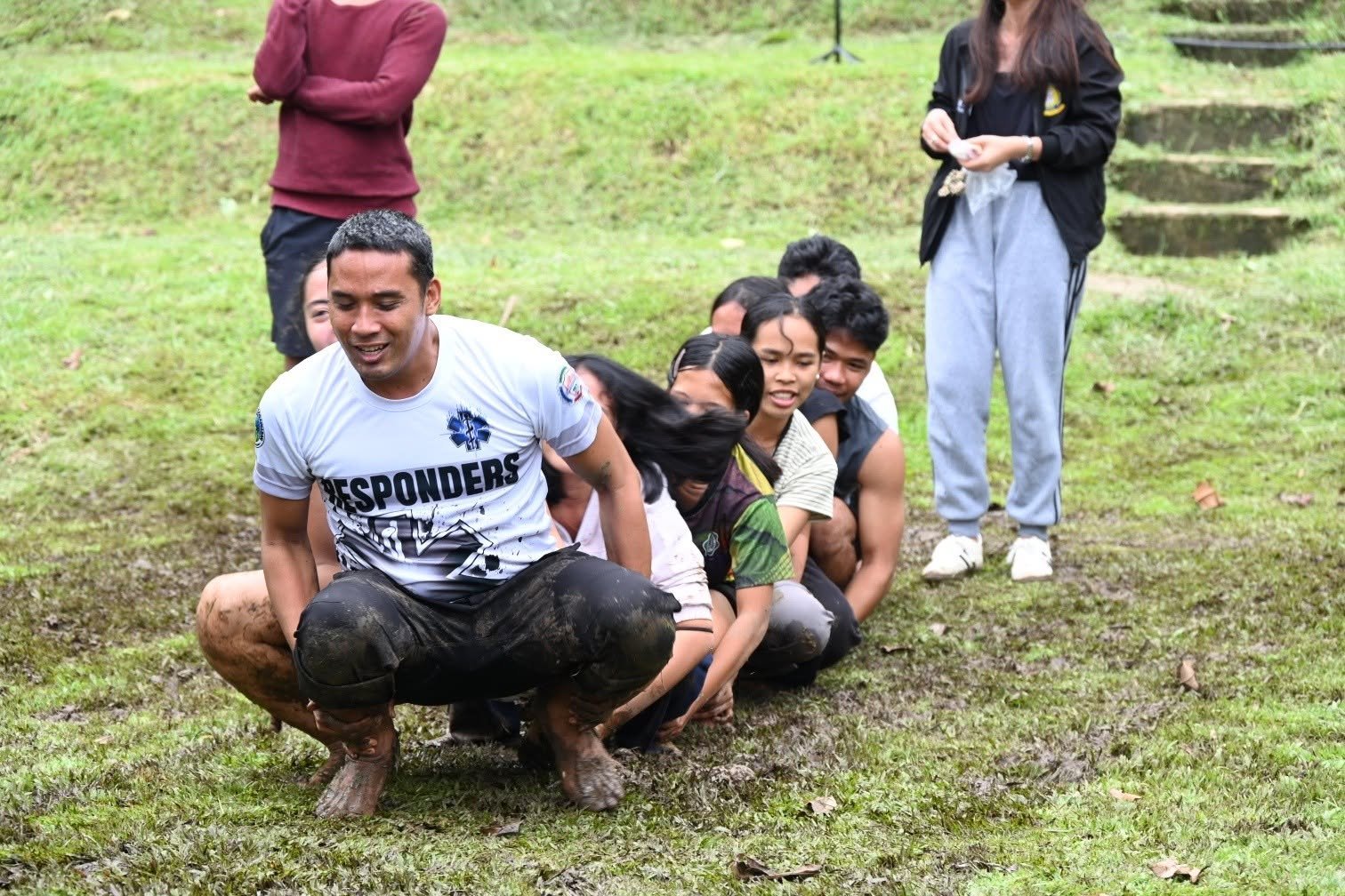Youth-camp participants gather outdoors at Lake Maragang.